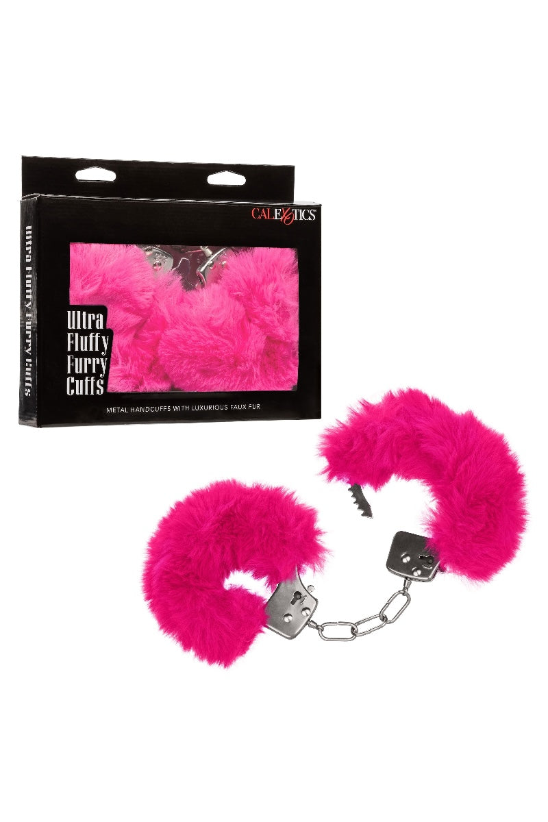 Pink furry handcuffs with packaging on a white background