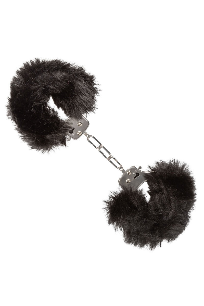 Black furry handcuffs on a white background