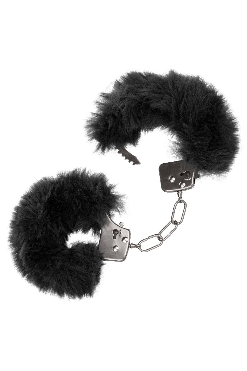 Black furry handcuffs on a white background