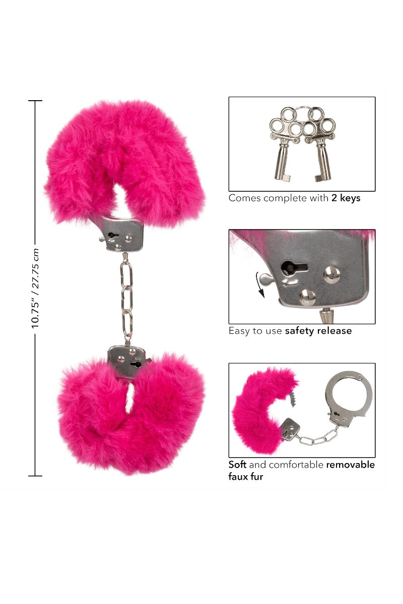 Pink fluffy handcuffs with keychains and safety release mechanism on a white background
