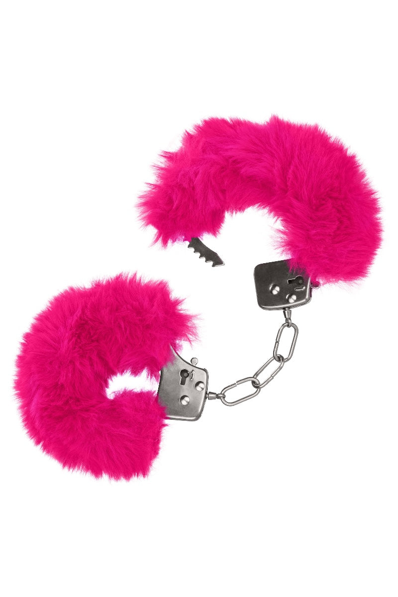 Pink furry handcuffs with metal clasps on a white background