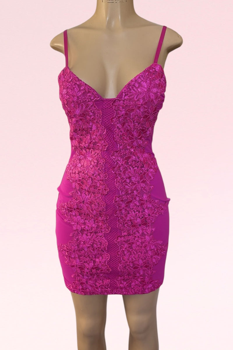 Pink lace dress on a mannequin against a pink background