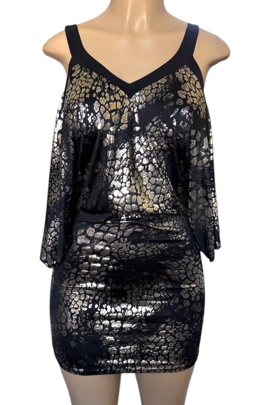 Black and gold sequin dress on a mannequin against a white background