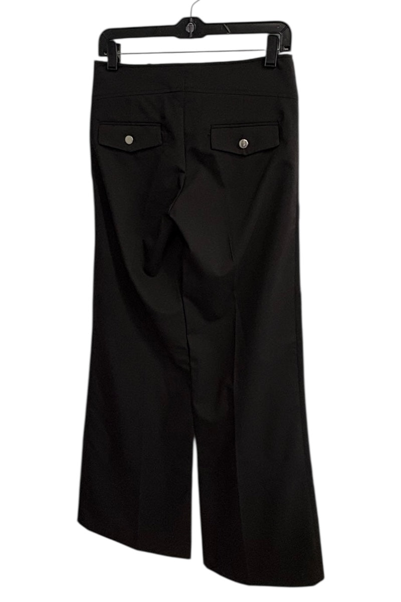 Black pants on a hanger against a white background