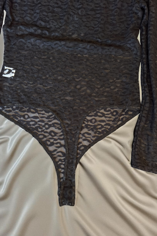 Black leopard print bodysuit on a beige surface