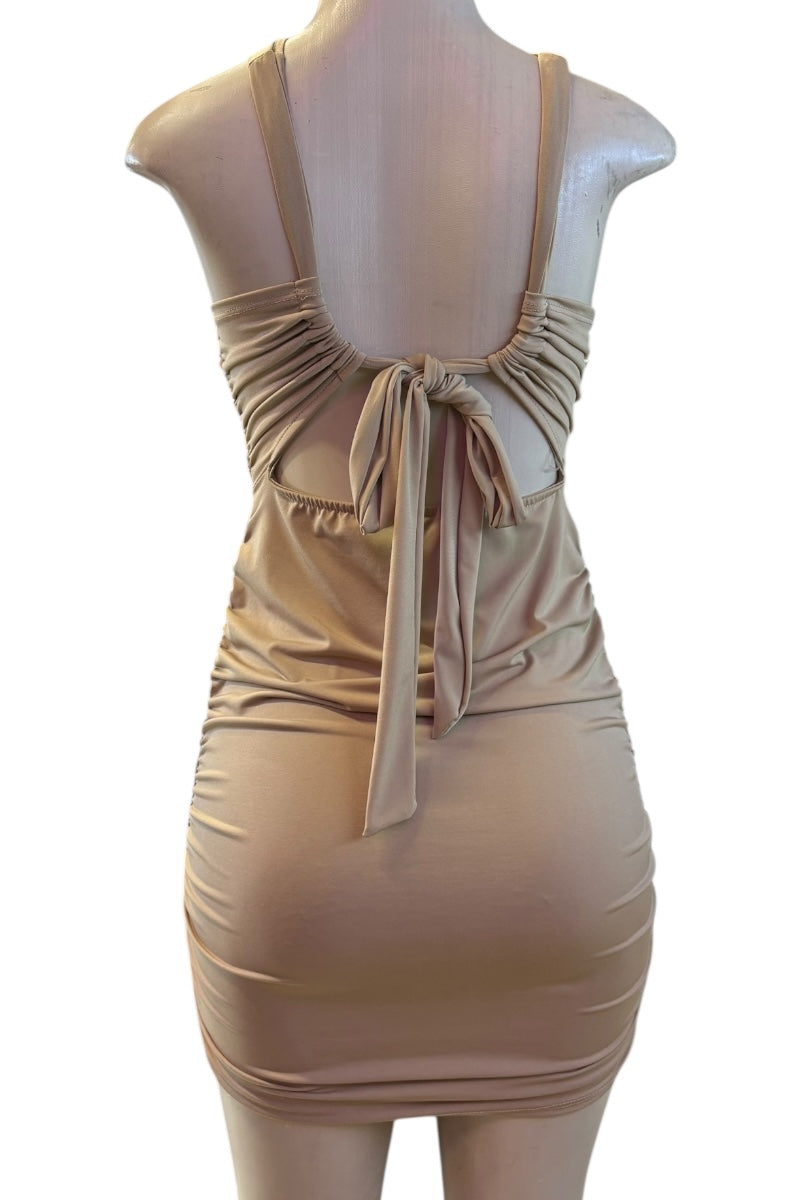Beige dress on a mannequin against a white background