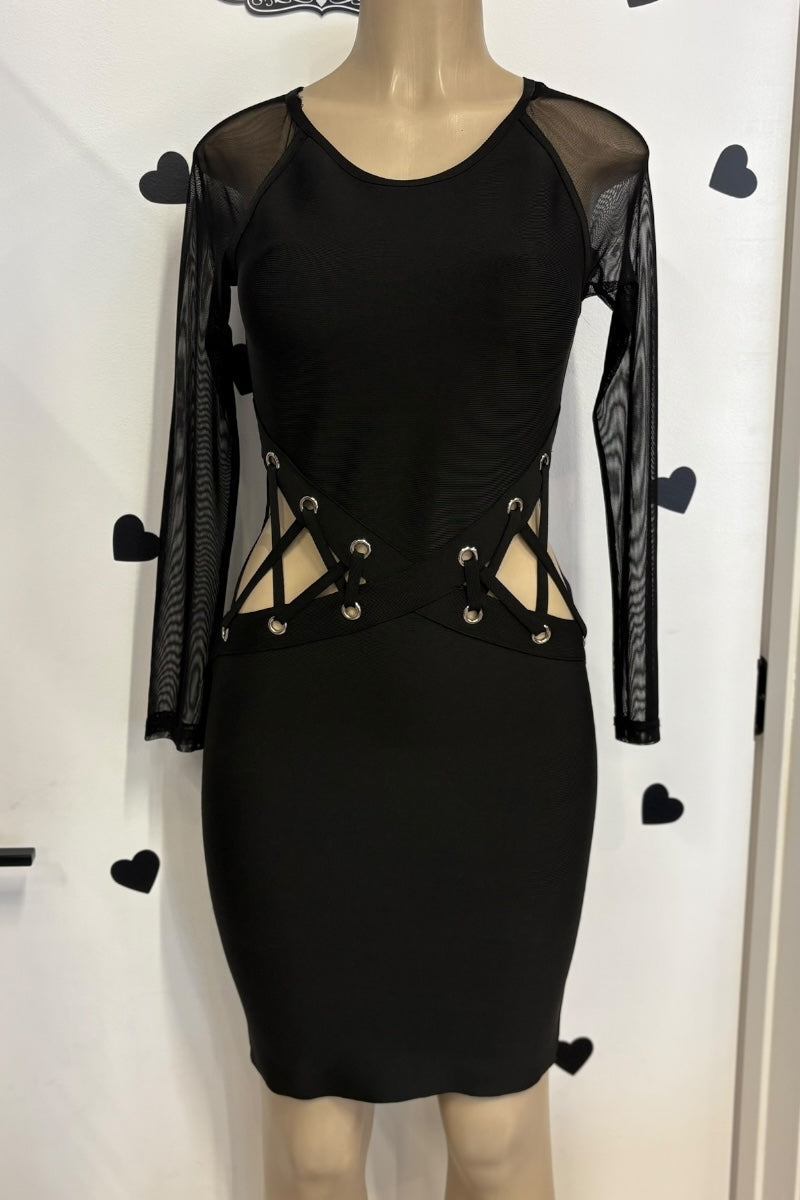 Black dress with sheer sleeves on a mannequin against a white background