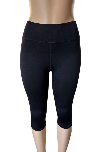 Black capri leggings on a mannequin against a white background