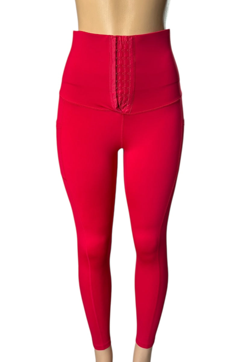 Red leggings with a corset waistband on a white background