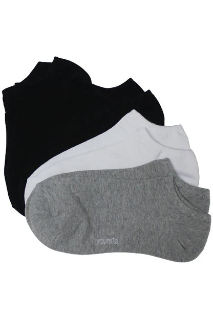 Three pairs of socks in black, white, and gray on a white background
