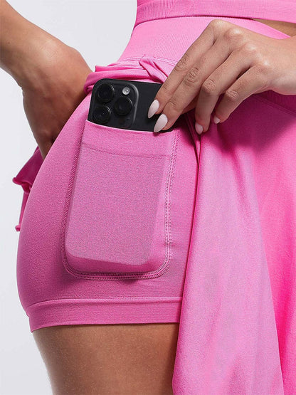 Person wearing pink athletic shorts with a pocket holding a phone.