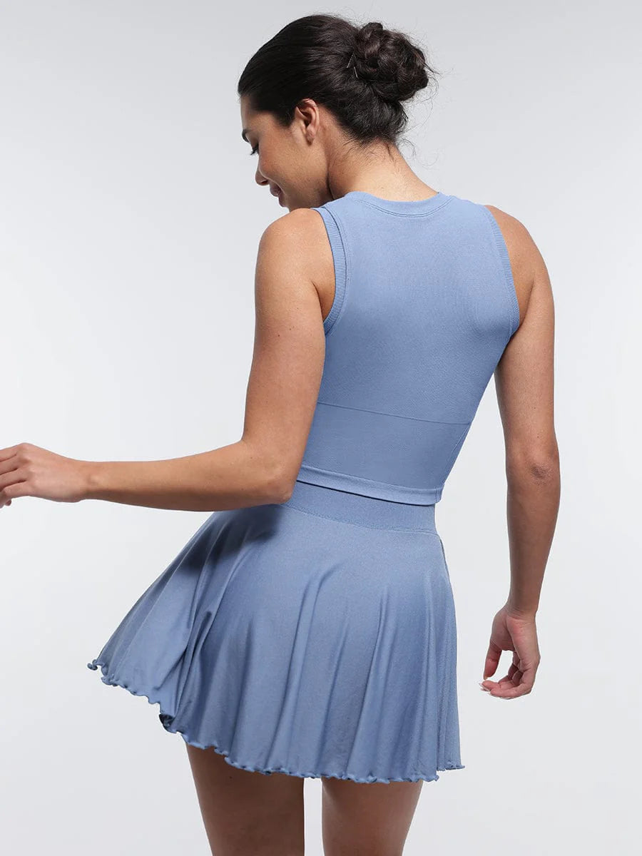 Woman wearing a light blue set against a white background