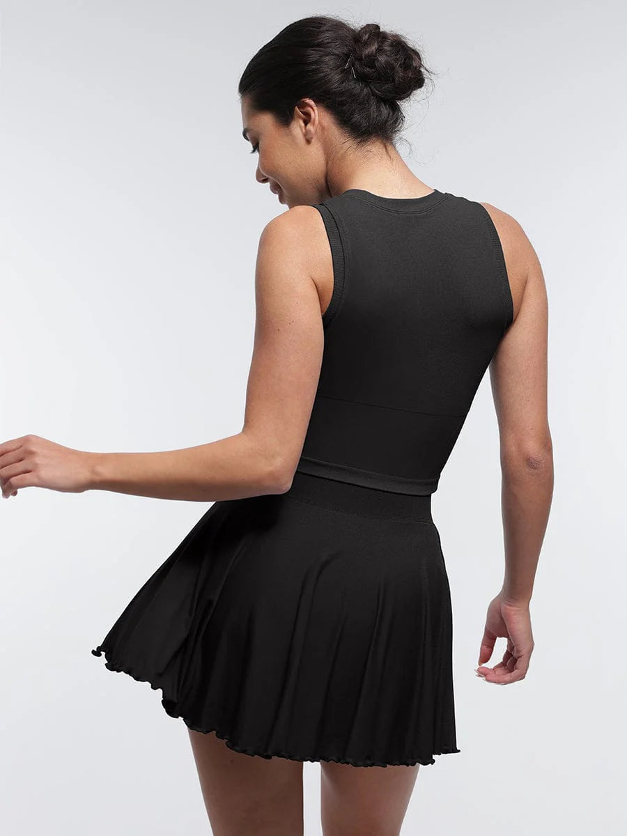 Woman wearing a black sleeveless top and skirt on a white background
