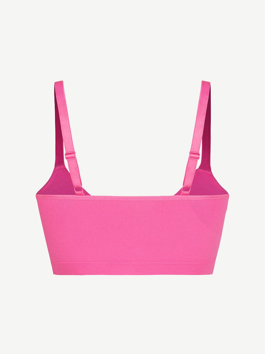 Fuchsia bralette with thin straps on a light gray background