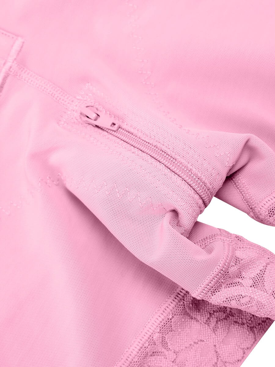 Close-up of a pink garment with lace detailing on a white background