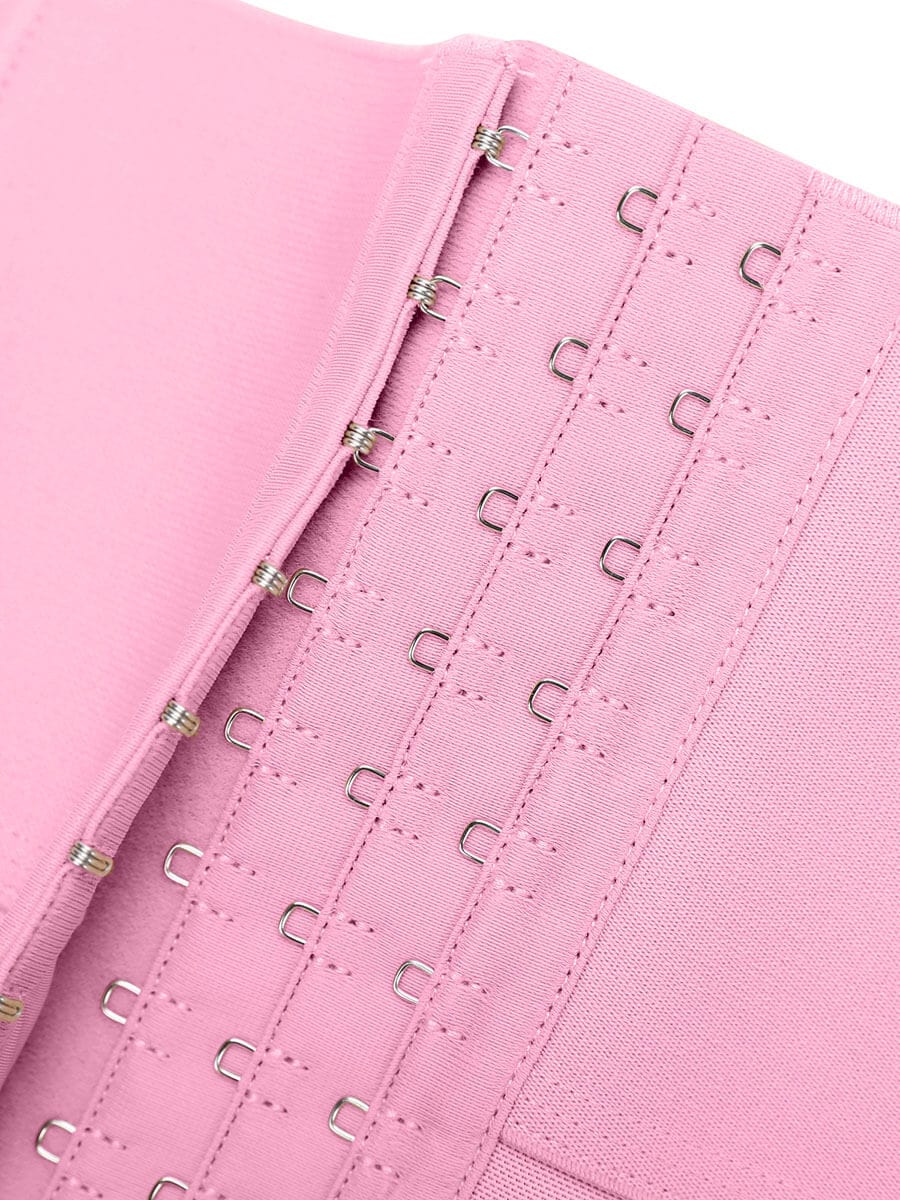 Close-up of a pink corset with metal hooks on a white background