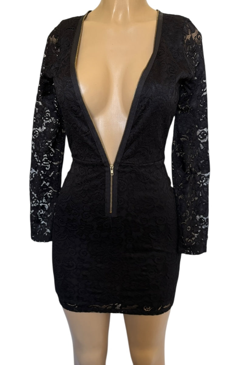 Black dress with long sleeves and a deep neckline on a mannequin against a white background