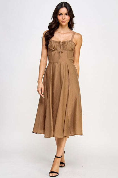 Woman wearing a brown dress on a white background