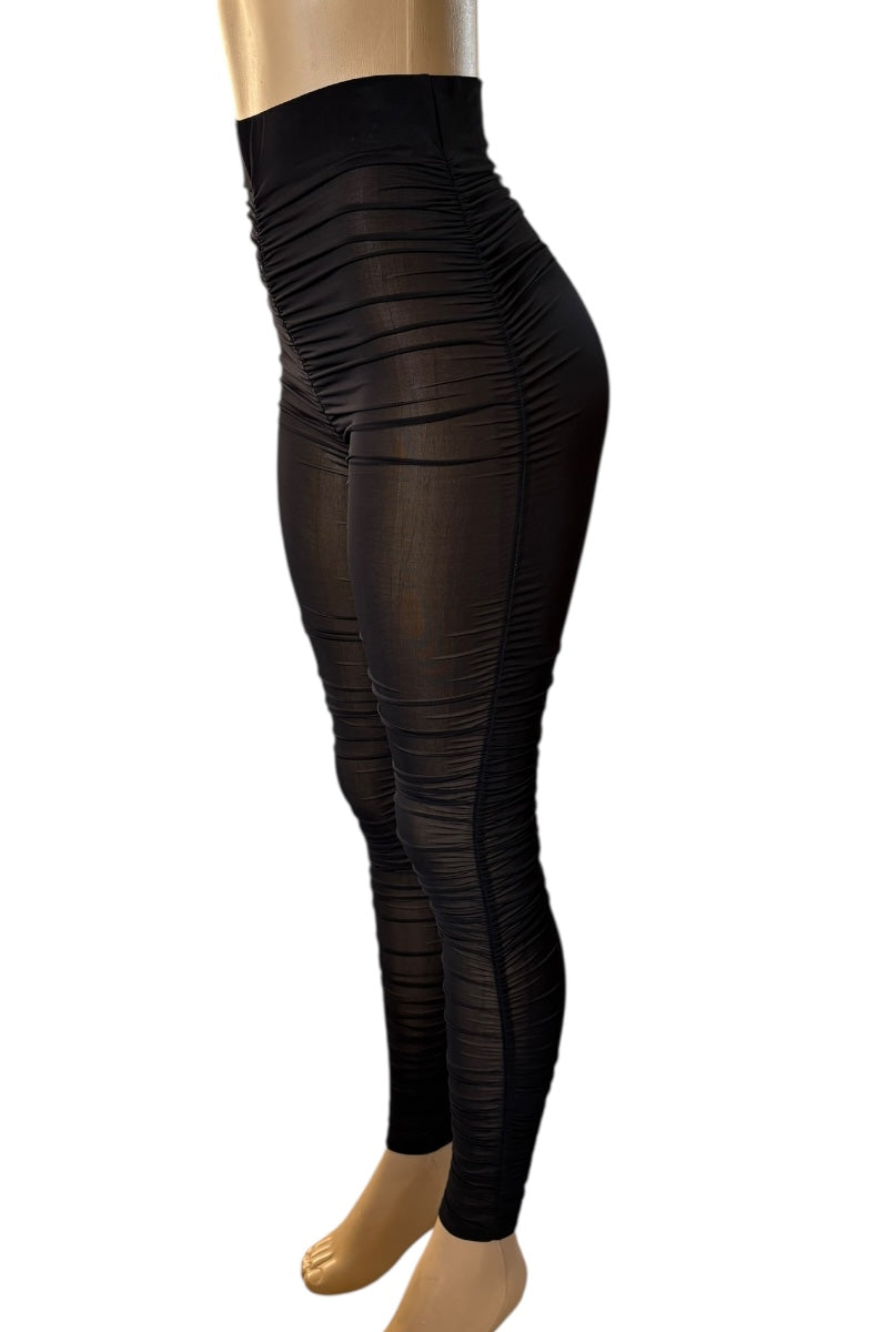 Black leggings on a mannequin against a white background