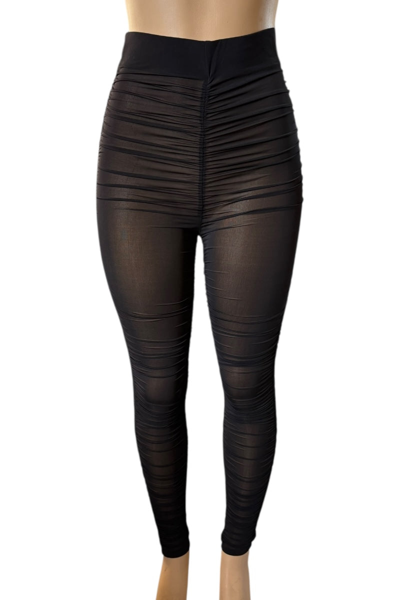 Black leggings on a mannequin against a white background