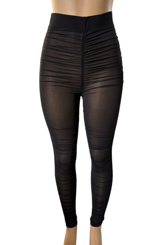 Black leggings on a mannequin against a white background