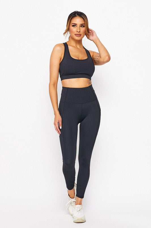 Woman wearing a black athletic outfit on a white background