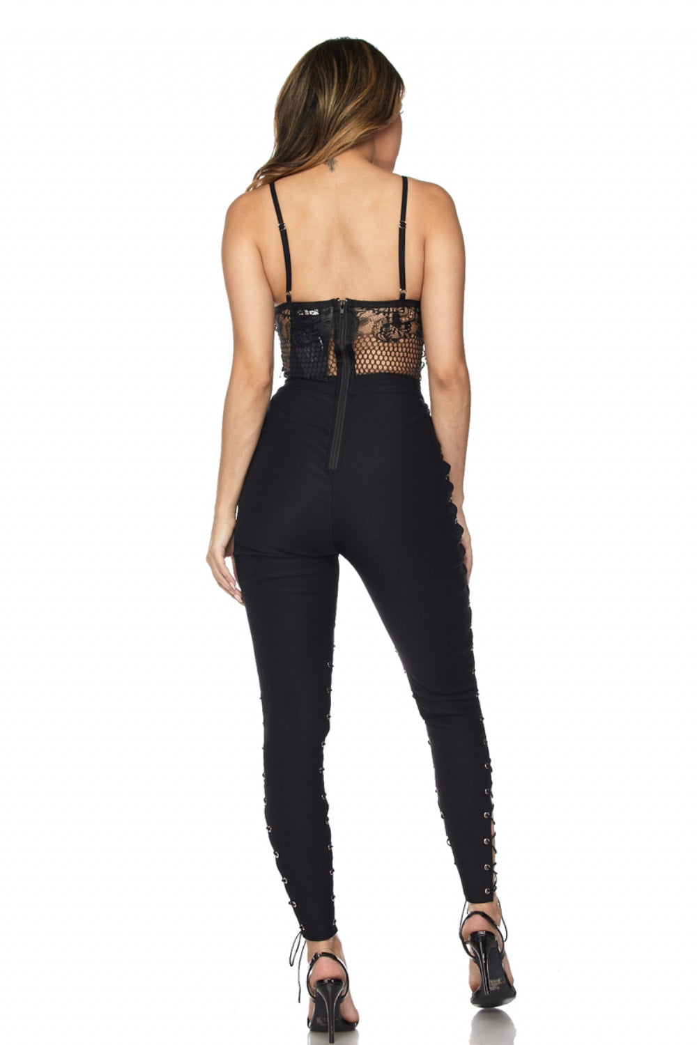 Black outfit with lace detailing on a white background
