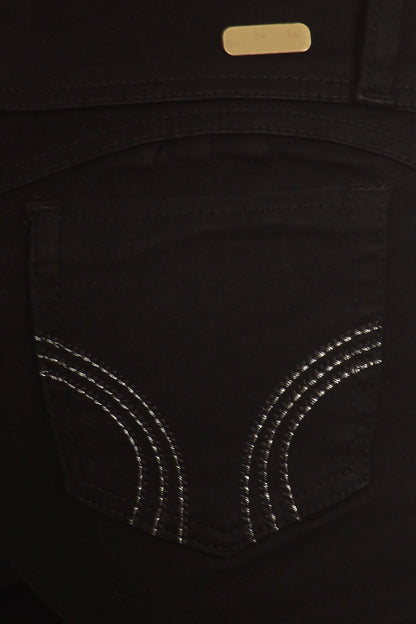 Close-up of a black pocket with silver stitching on a dark background