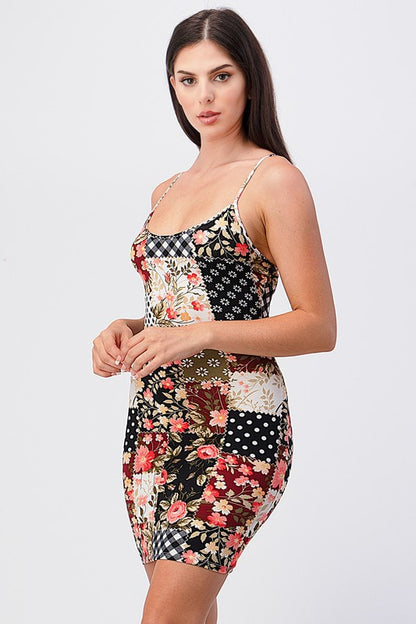 Woman wearing a patchwork dress with floral and geometric patterns on a white background