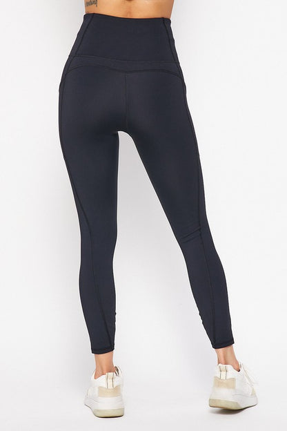 Black leggings worn by a person on a white background