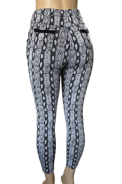 Snakeskin patterned leggings on a mannequin against a white background