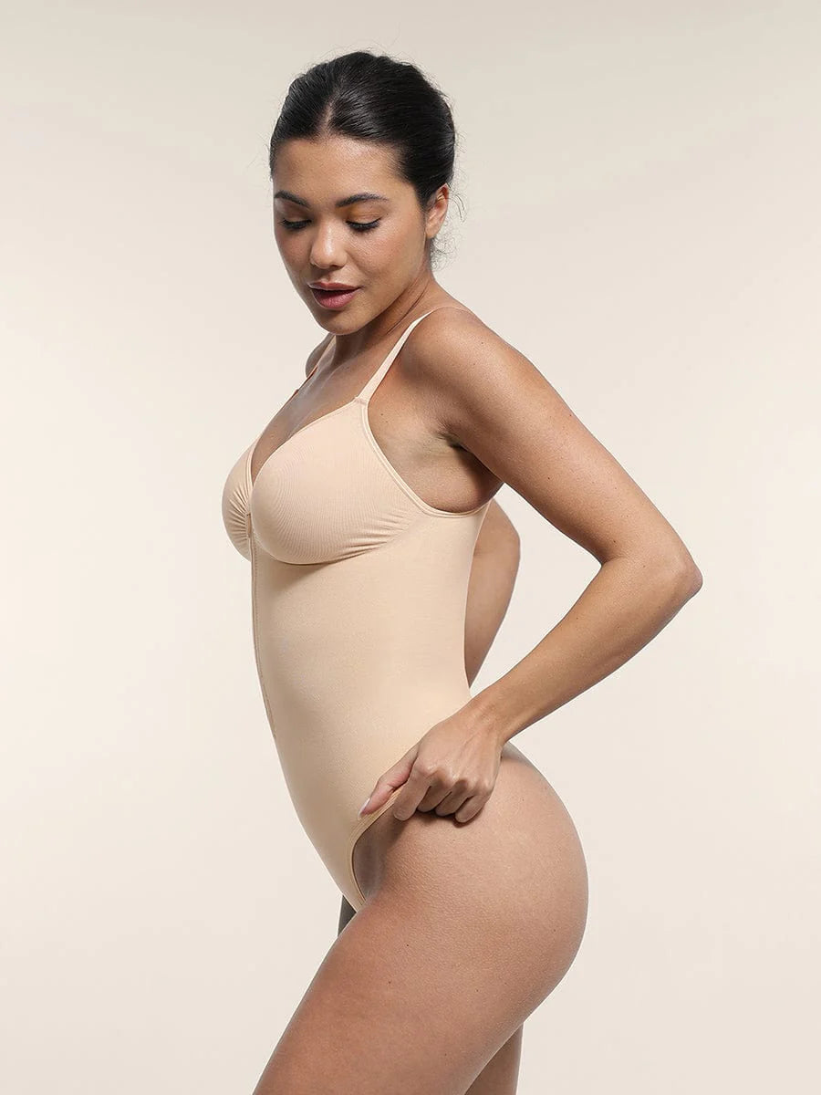 Woman wearing a beige bodysuit against a plain background