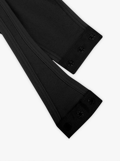 Close-up of black bodysuit with buttons on a white background