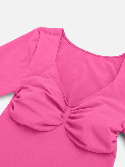 Pink top with a scrunched detail on a white background