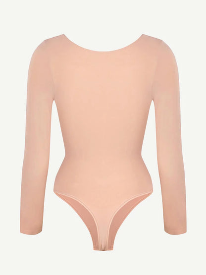 Nude-colored bodysuit with long sleeves on a light gray background