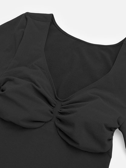 Black top with a scrunched detail on a white background
