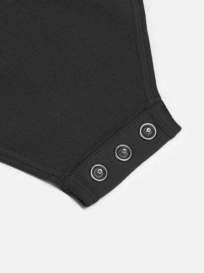 Close-up of a black bodysuit with buttons on a white background