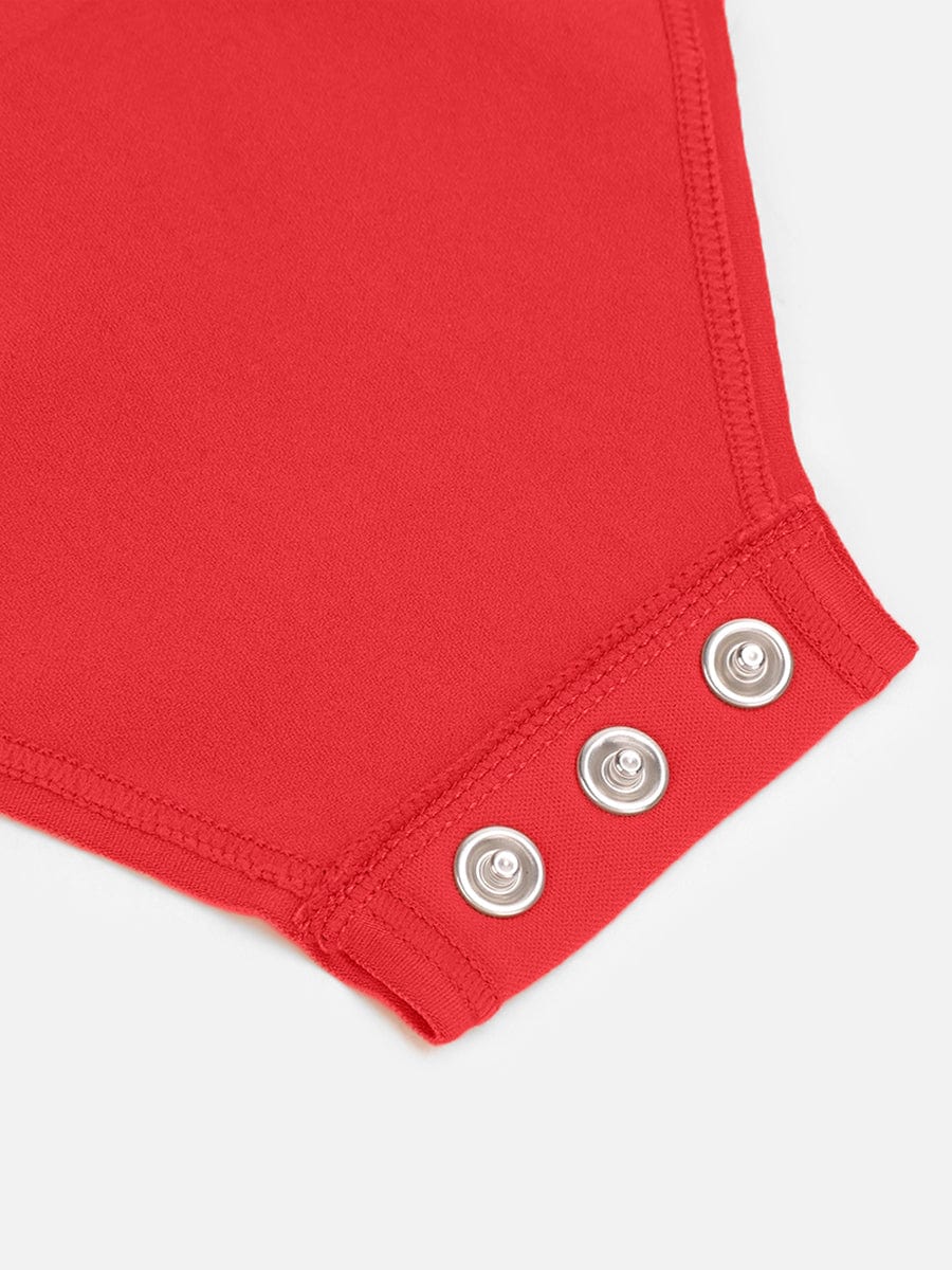 Close-up of a red garment with silver buttons on a white background