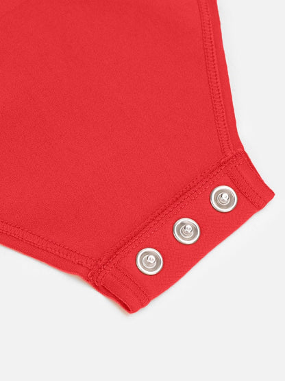 Close-up of a red garment with silver buttons on a white background