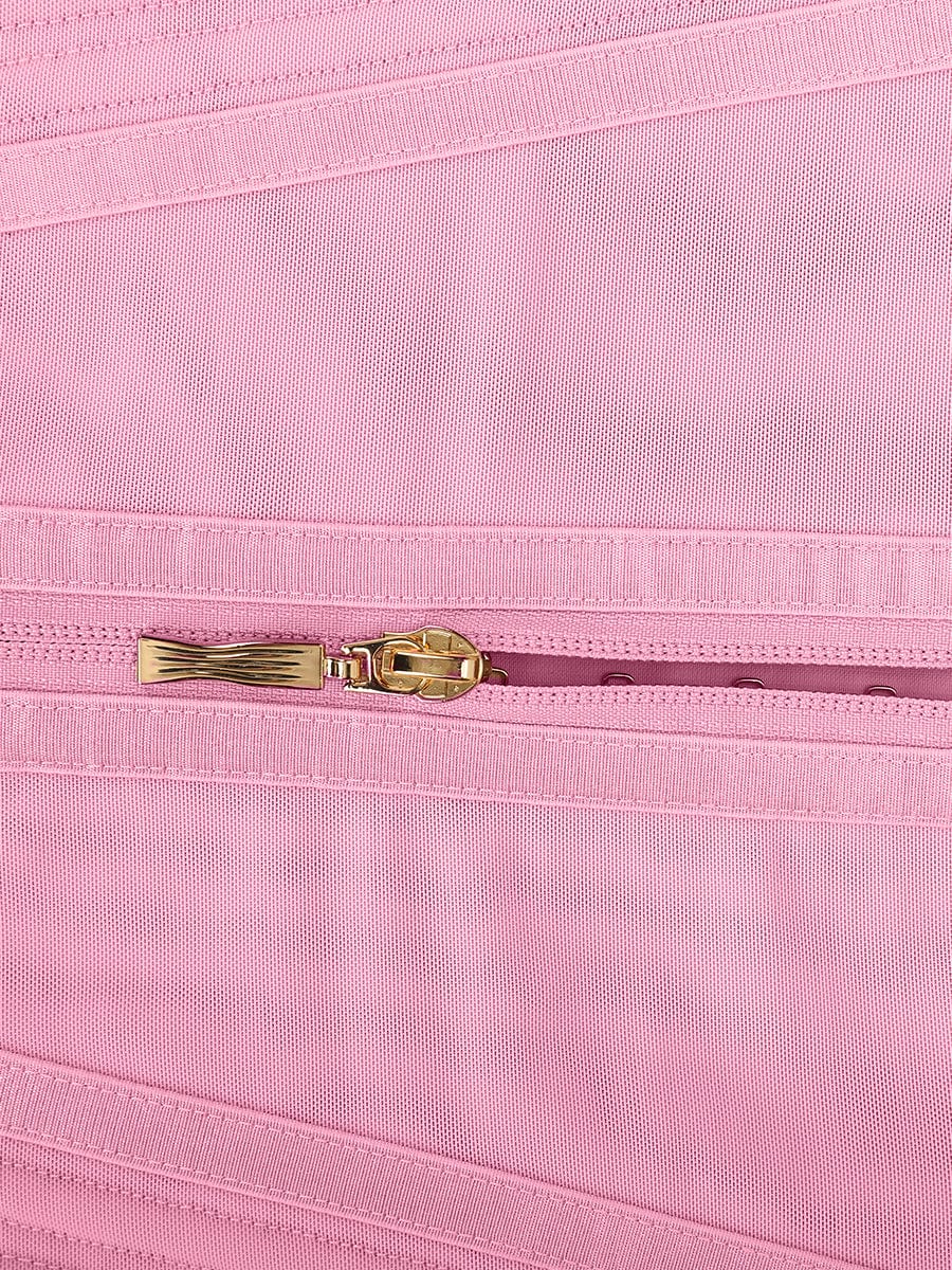 Close-up of a pink fabric with a gold zipper