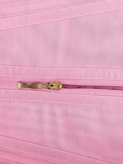 Close-up of a pink fabric with a gold zipper
