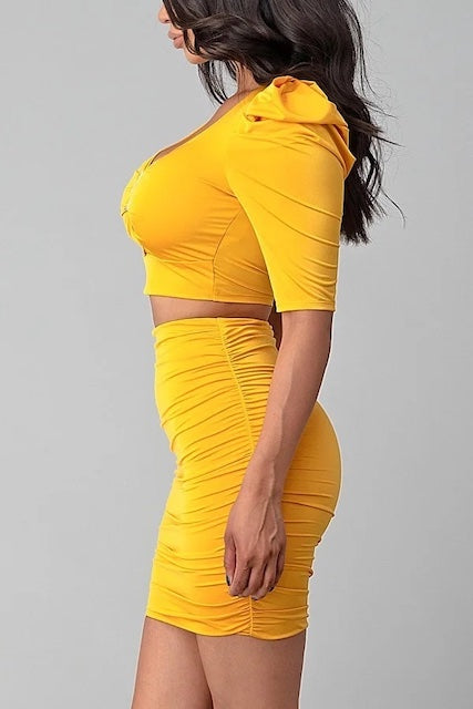 side view of Puffy Sleeves, Diamond Buckle Crop Top W/ Matching Skirt shown in mustard color