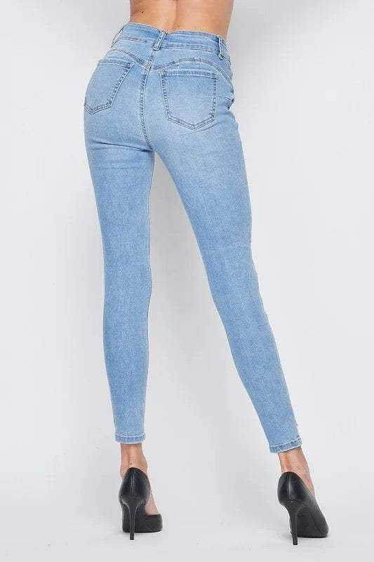 Back of Figure Hugging Distressed Skinny Jeans in Light Blue Color